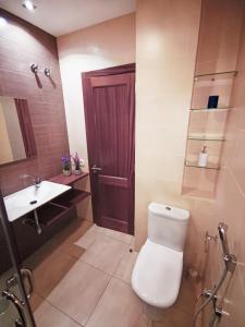 a bathroom with a toilet and a sink at Citybeach - parking & wifi in Las Palmas de Gran Canaria