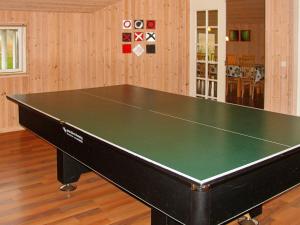 a ping pong table in a room at Holiday home Idestrup III in Marielyst