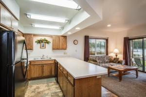 a kitchen with a sink and a refrigerator at Pend Oreille Shores Resort in Hope