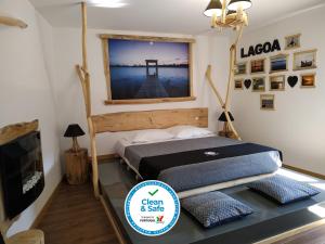 a bedroom with a bed and a tv in a room at Atlantic Spot Guest House in Praia de Mira