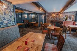 a restaurant with tables, chairs, and tables in it at Royal Oak Appleby in Appleby