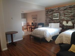 a hotel room with two beds and a brick wall at Stay Saratoga in Saratoga Springs +60 photos