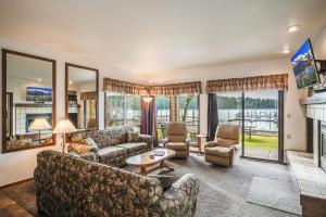 a living room with a couch and chairs and a fireplace at Pend Oreille Shores Resort in Hope