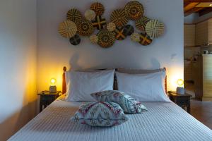 a bedroom with a bed with two pillows and hearts on the wall at Madalena's Summer House in Adamantas