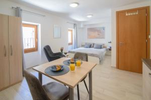 a living room with a table and a bedroom at Old Town Studio in Novigrad Istria