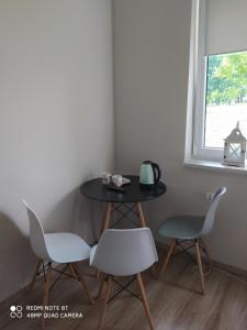 a table and two chairs and a table and a window at U Józefa in Tychy +29 photos