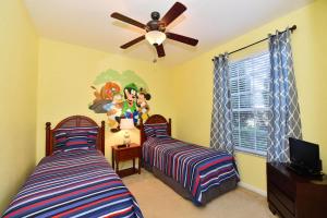 A bed or beds in a room at The Windsor Hills Resort Condos by Florida Star Vacations