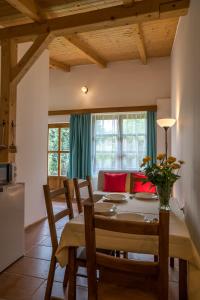 a kitchen and dining room with a table and chairs at Hajnalka Apartment in Badacsonytomaj