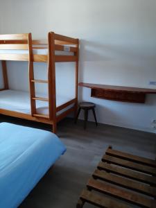 a bedroom with a bunk bed and a desk at Home des Pins SARL in Saint-Pierre-Quiberon