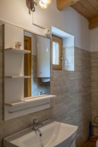 a bathroom with a sink and a mirror at Hajnalka Apartment in Badacsonytomaj