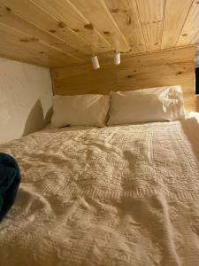 a bed in a room with a wooden ceiling at Cosy Apartment Tara Edelweiss at Skiing Resort of Falls Creek in Falls Creek