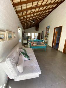 a living room with a white couch and a table at BEM ESTAR À BEIRA MAR in Ubatuba +146 photos