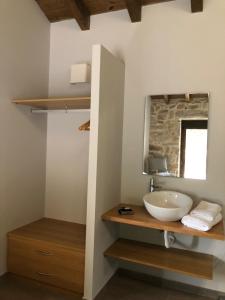 a bathroom with a sink and a mirror at Casa Yañez • XuresVillas in Bubaces +30 photos