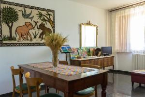 a room with a table with chairs and a desk at Le Monachette in Ascoli Piceno