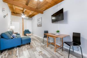 a living room with a blue couch and a table at Darien Dockside Inn in Darien