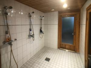 a bathroom with a shower with a window at Harmaalokki in Savonlinna