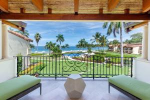 a balcony with a view of the ocean at Spacious Open-Concept Condo with Stylish Design, Direct Beach Access & Resort-Style Amenities in Playa Flamingo