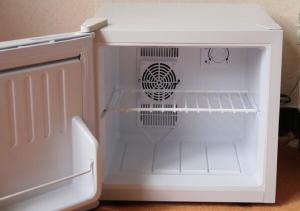 a small white refrigerator with its door open at Dai Onsen Matsudaya Ryokan - Vacation STAY 67479 in Hanamaki