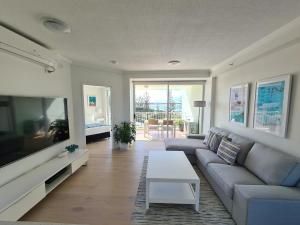 a living room filled with furniture and a tv at Crystal Bay On The Broadwater in Gold Coast