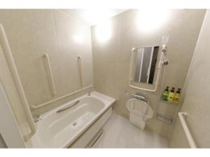 a bathroom with a tub and a toilet and a sink at Act Hotel Roppongi - Vacation STAY 85367 in Tokyo