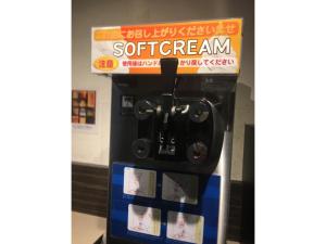 a coffee machine with a sign on top of it at Act Hotel Roppongi - Vacation STAY 85368 in Tokyo