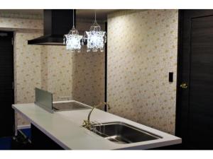 a kitchen with a sink and two chandeliers at Act Hotel Roppongi - Vacation STAY 85368 in Tokyo