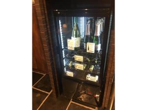 a refrigerator filled with lots of bottles of alcohol at Act Hotel Roppongi - Vacation STAY 84277 in Tokyo