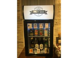 a refrigerator filled with lots of bottles of beer at Act Hotel Roppongi - Vacation STAY 84277 in Tokyo