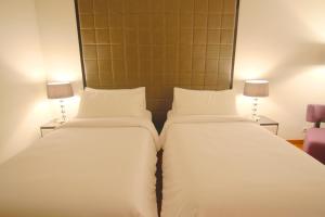 Ein Bett oder Betten in einem Zimmer der Unterkunft Hotel Diradja