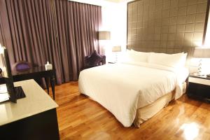 Ein Bett oder Betten in einem Zimmer der Unterkunft Hotel Diradja