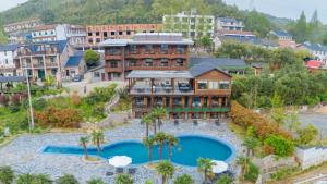 an aerial view of a resort with a swimming pool at Moganshan Xiaoyao Holiday Inn in Deqing