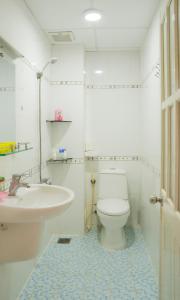 a bathroom with a white toilet and a sink at Aqua Nhu Huynh Hotel in Ho Chi Minh City