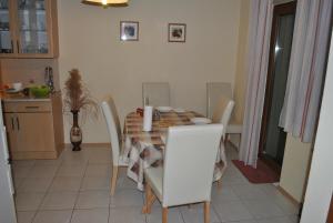y cocina con mesa de comedor y sillas. en Anett Apartman, en Siófok
