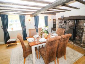a dining room with a table and chairs and a fireplace at 82 The Square in Bideford