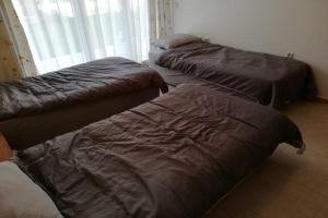 three beds sitting in a room with a window at Yves 2 Bed apart at Sun Village Sunny Beach not far away from the sea in Sunny Beach