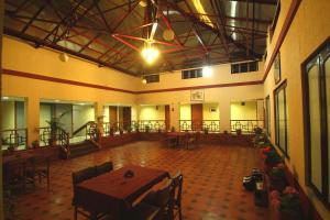 a room with a table and chairs in a building at Hotel Preethi Classic Towers in Ooty