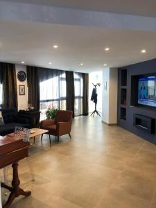 a living room with a couch and a tv at LOFT La Grande Motte in La Grande-Motte