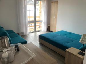 a living room with a blue bed and a couch at Jantarowy Sen in Jantar +52 photos