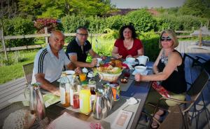 a group of people sitting around a table eating food at Entre montagnes et lac in Armoy