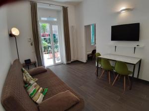 a living room with a couch and a table and a television at Cinque Terre Step in La Spezia