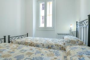 Un dormitorio con dos camas y una ventana. en il giardino di Riomaggiore, en Riomaggiore