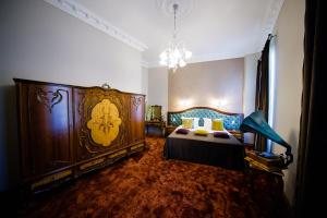 a bedroom with a large bed and a chandelier at Grand Hotel Traian in Iaşi