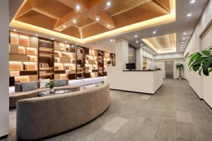 a lobby with a waiting area with couches and books at Wing Hotel Guilin- Pedestrian Street in Guilin