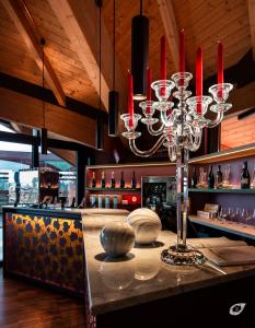 a restaurant with a bar with a chandelier at Buonamico Wine Resort in Montecarlo
