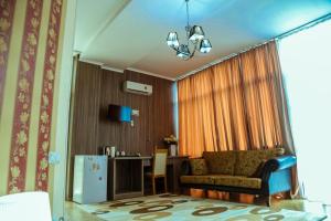 a living room with a couch and a table at Hotel Borjomi Aisi in Borjomi
