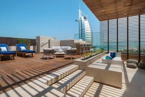 a rooftop patio with a view of a building at Jumeirah Al Naseem Dubai in Dubai