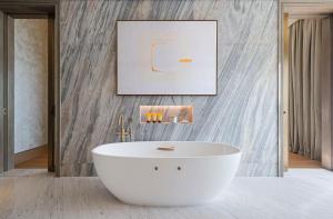 a bathroom with a white tub in a room at Jumeirah Al Naseem Dubai in Dubai