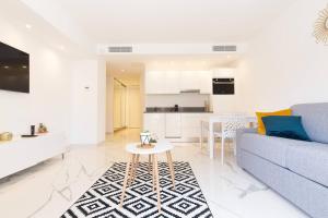 a living room with a couch and a table at Brand new 2 bedrooms next to Croisette ! in Cannes
