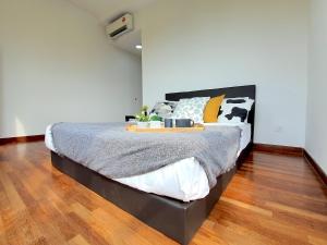a bedroom with a bed with a tray on it at I-City Shah Alam by BeeStay Management in Shah Alam