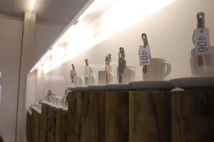 a row of coffee mugs with price signs on them at HOTEL ALBA in Montecatini Terme